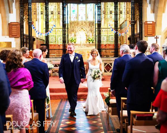 Bride and groom leaving church after service.