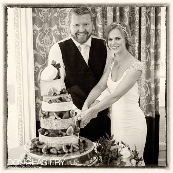 Bride and groom cutting cake at RAC in Epsom