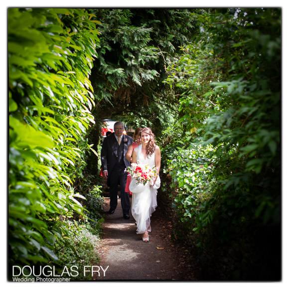 Bride arriving at Church through woodland walk