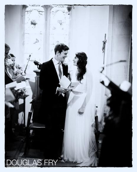 Black and white photograph of couple during wedding in Church