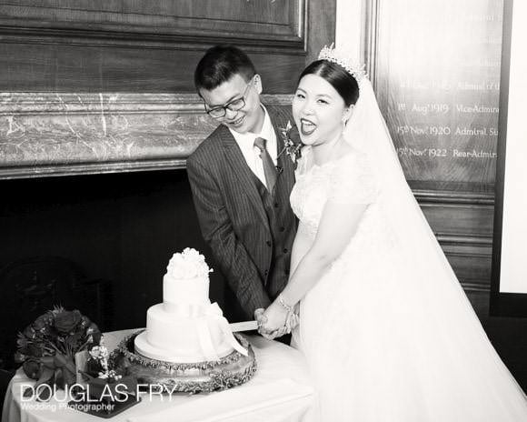 Couple cutting cake at Old Royal Naval College