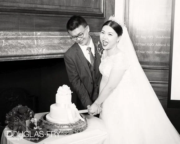 Wedding Photographer The Admirals House, Old Royal Naval College in Greenwich 8 Couple cutting cake at Old Royal Naval College