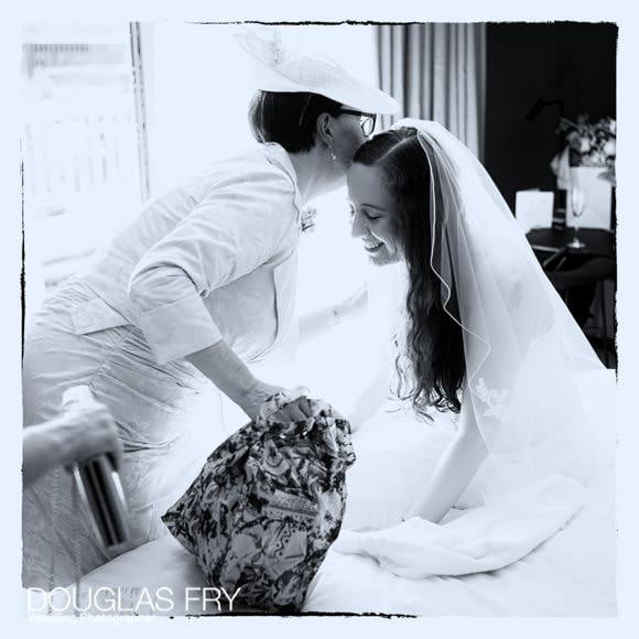 Bride and mother of the bride getting ready - black and white photograph