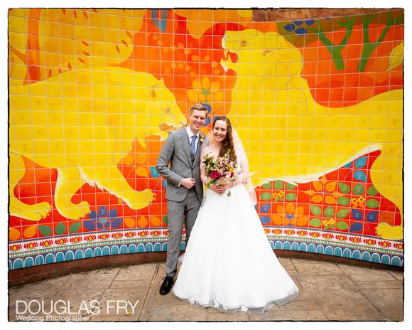 Wedding picture by lion murial at London Zoo