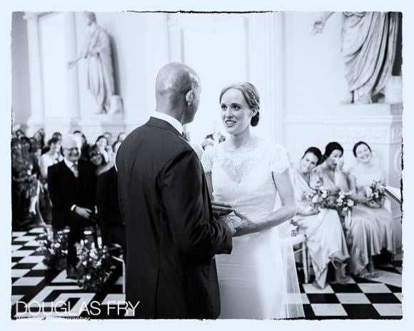Bride and groom exchanging vows - black and white photograph at Syon House