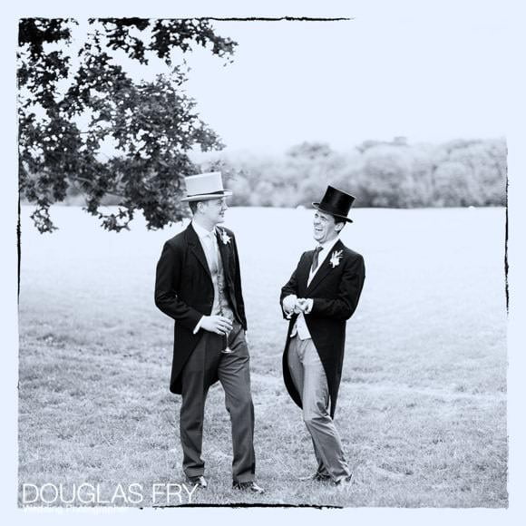 Guests wearing top hats at wedding reception near Abingdon - black and white photograph