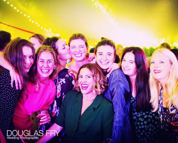 Guests at wedding during dancing phase of reception - pictured in marquee