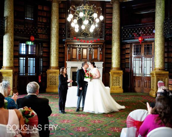 Bride and groom kissing at end of wedding ceremony