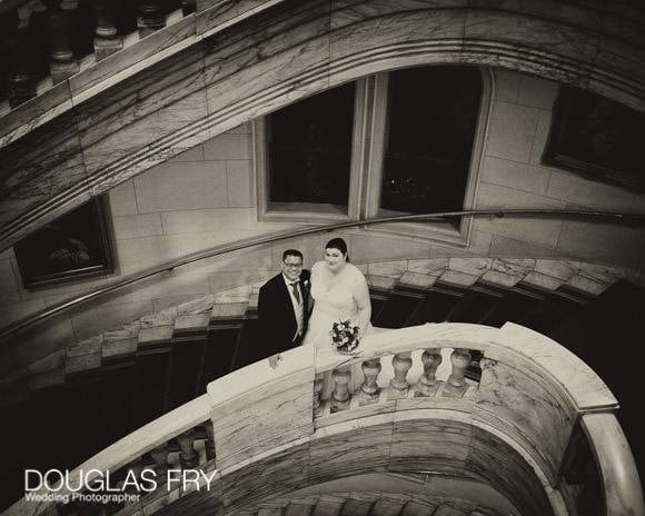 The couple photographed on the stairs at One Whitehall Place