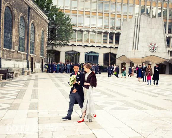 Wedding Photographer at St Lawrence Jewry & Merchant Taylors' Hall 4 Bride and groom photogrpahed in front of St Lawrence Jewry walkibng through London