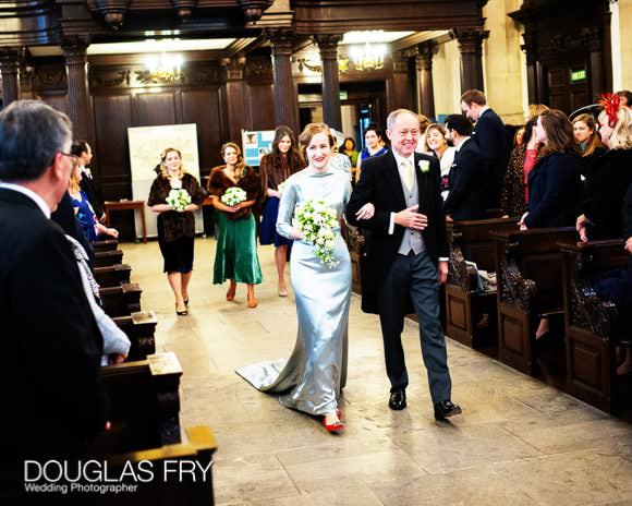 Bride and father of the bride walking down aisle at St Lawrence Jewry in London