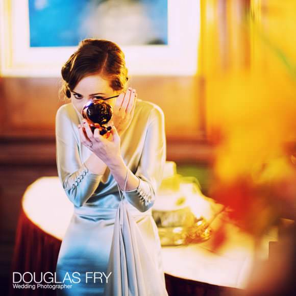 bride photographed putting on make up at Church