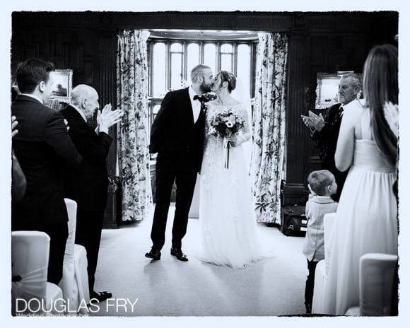 Bride and groom kissing at end of ceremony to celebrate marriage