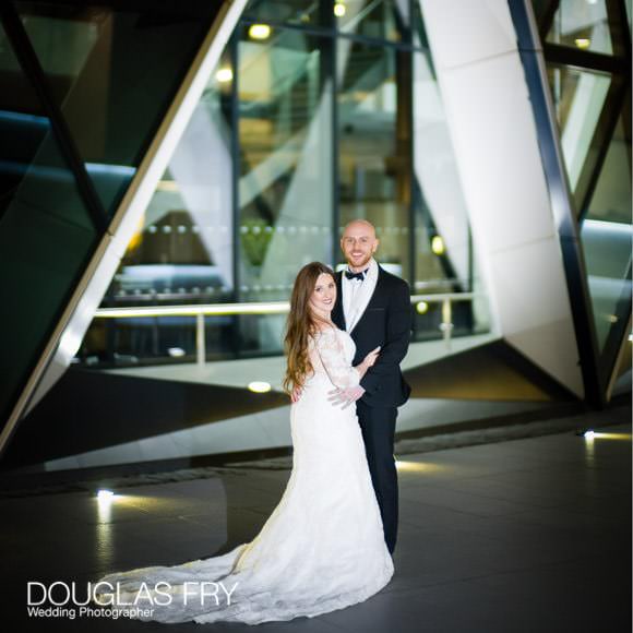 Couple standing outside Searcy's the Gherkin - photographed by Douglas Fry Wedding Photographer
