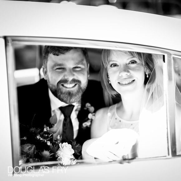 Wedding Photographer Chelsea and The Bulls Head in Barnes - Alicia & Harry 25 Couple in wedding car on way to reception in Barnes