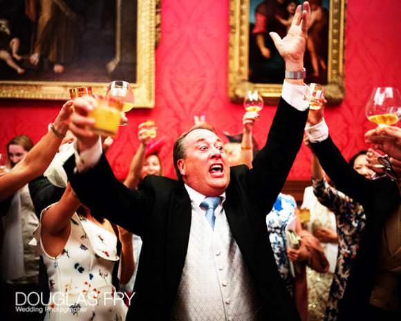 Guests toasting the couple at their wedding