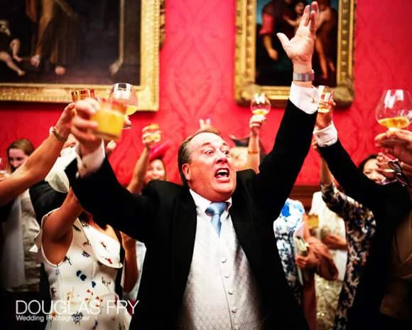 Wedding Photographer St George's Hanover Square and Kensington Palace 8 Guests toasting the couple at their wedding