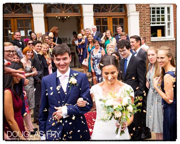 couple with confetti in front of london venue