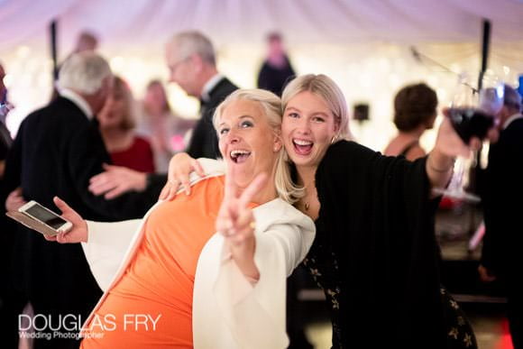 Guests dancing on dance floor at party