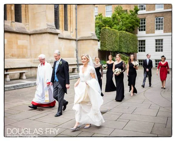 Wedding Photographer Two Temple Place - A Spectacular and Unusual London Venue 2 Bride with father and bridesmaids walking towards entrance to Temple Church