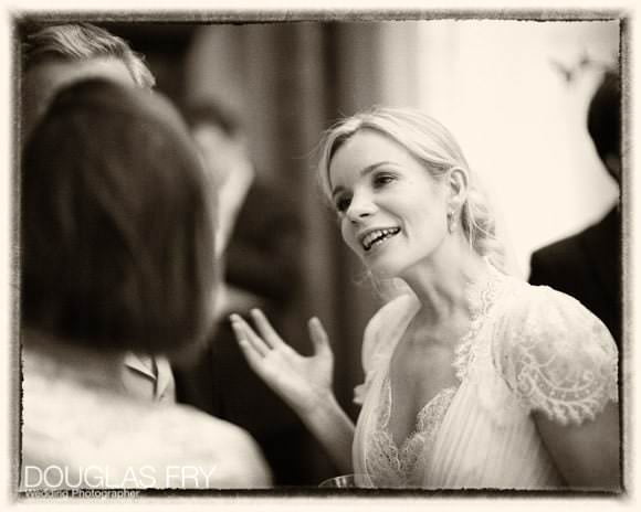 Bride pictured in conversation during wedding reception