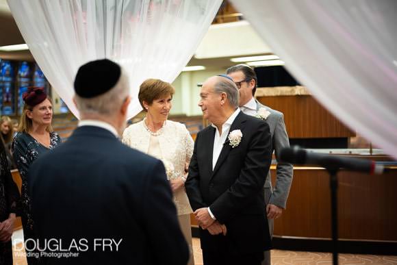 Bride and groom photographed under the chuppah