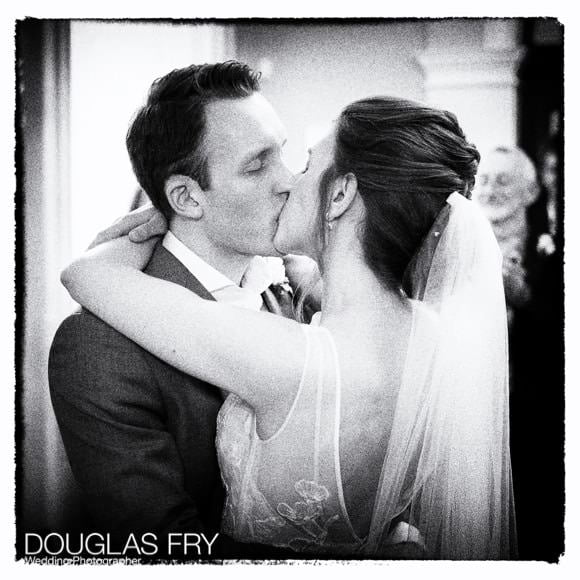 Bride and groom kisssing at end of wedding ceremony