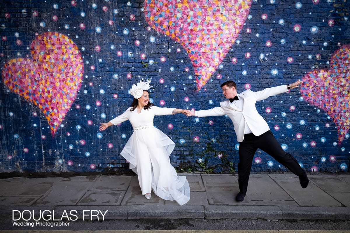 Bride and groom photographed in front of London Mural
