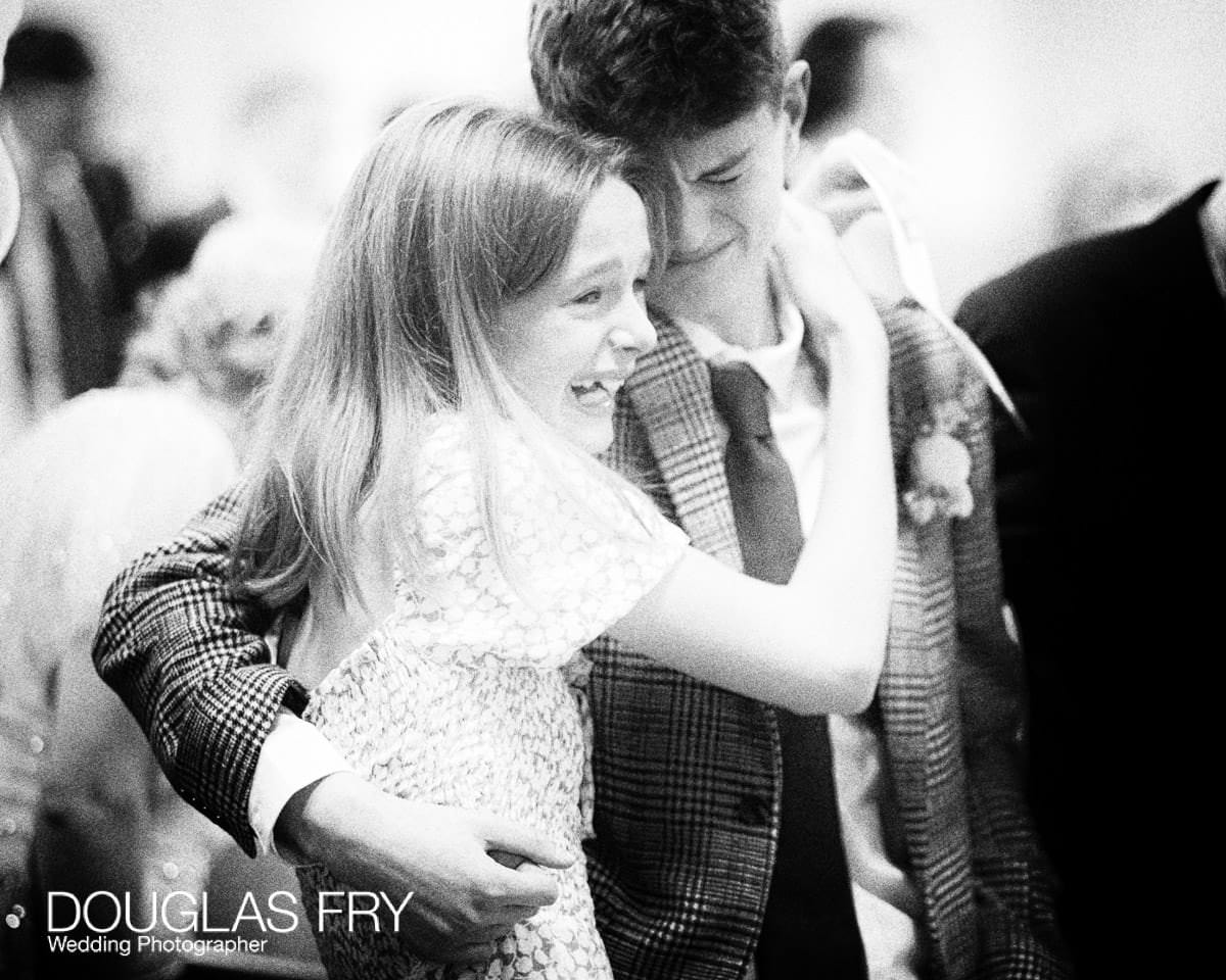 Emotional photograph of two children during wedding service at London Church