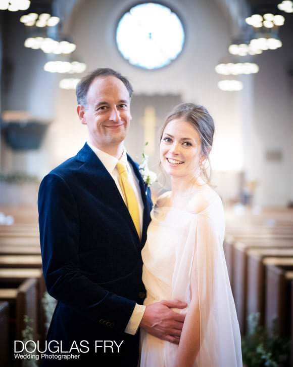 The wedding couple pose for some portraits in the foyer of the church