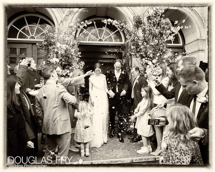 Guests shower the couple with confetti as they leave the church