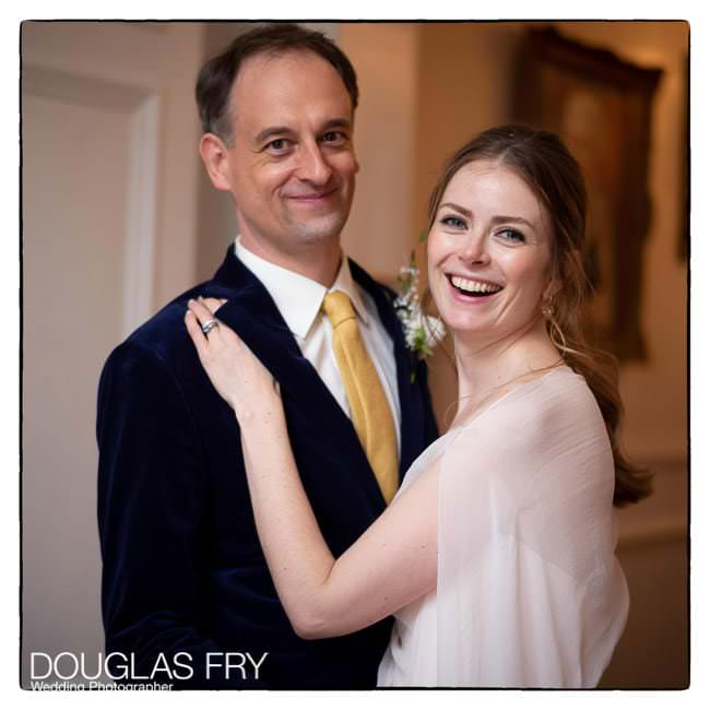 Bride and groom laughing together at Ognisko in London - The Polish Hearth Club