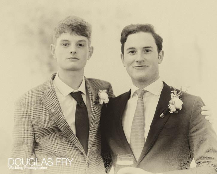 The grooms son and guest pose for a portrait together