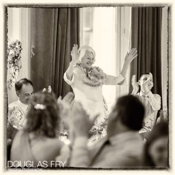 Mother of the groom enjoys a toast during the speeches