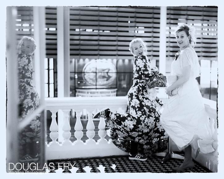 Wedding Photographer Ognisko and St Columbas Church in London 10 Two guests posing for a fun photograph on the balcony