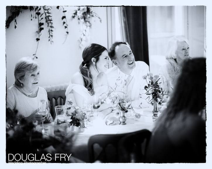 The wedding couple enjoying the speeches