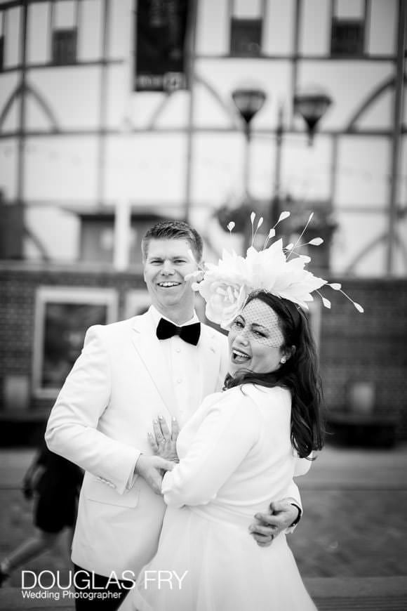 Wedding couple pose next to Shakespeare's Globe on London's South Bank