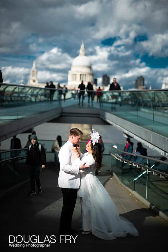 Wedding couple caught in sunshine on the Millenium Bridge on London's South Bank