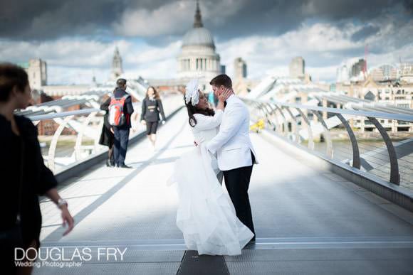 Portraits of the wedding couple posing on the Millennium Bridge