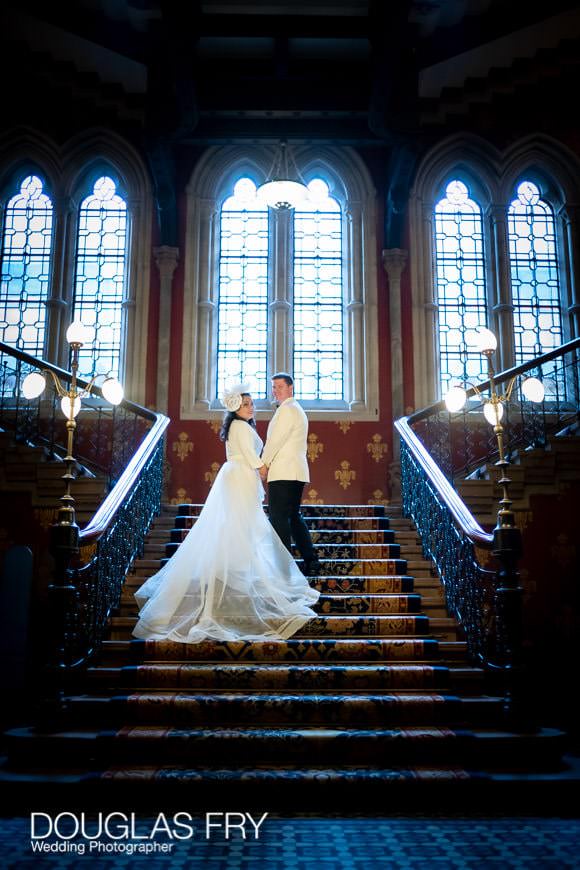 wedding couple posing on the stairs of The Landmark hotel in London