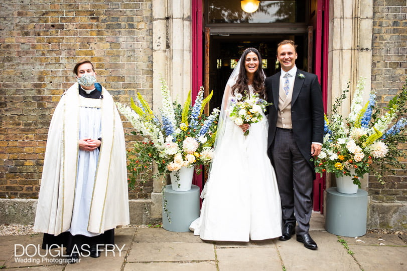 couple in front of London church with facemask