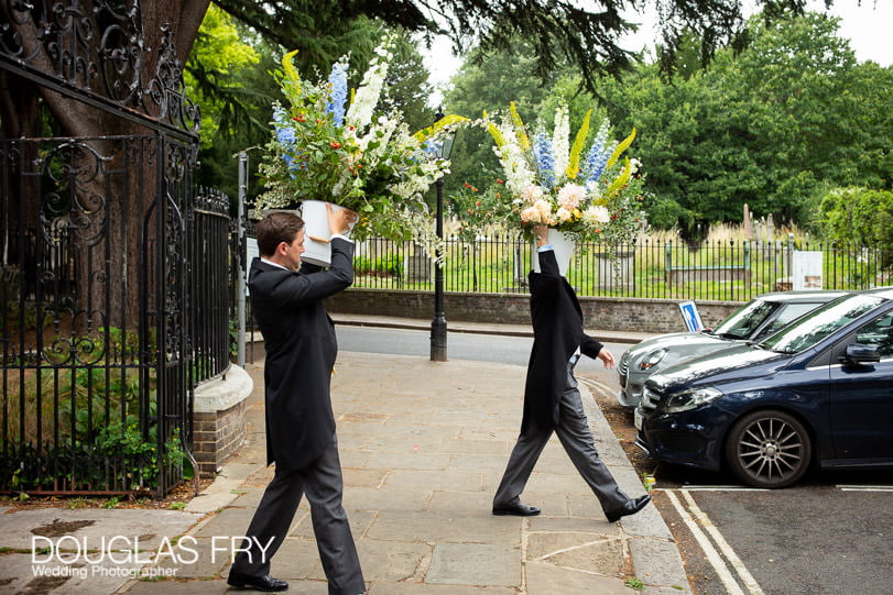 ushers carrying flowers to the reception restaurant in London
