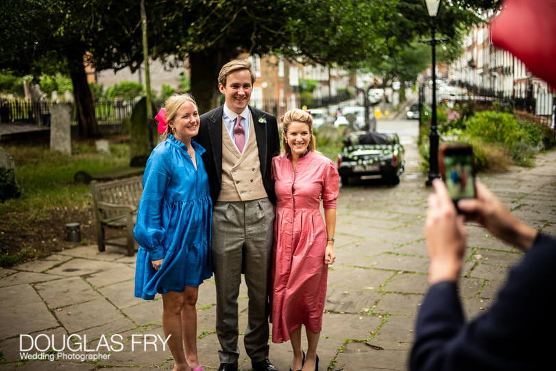 Guests being photographed at wedding