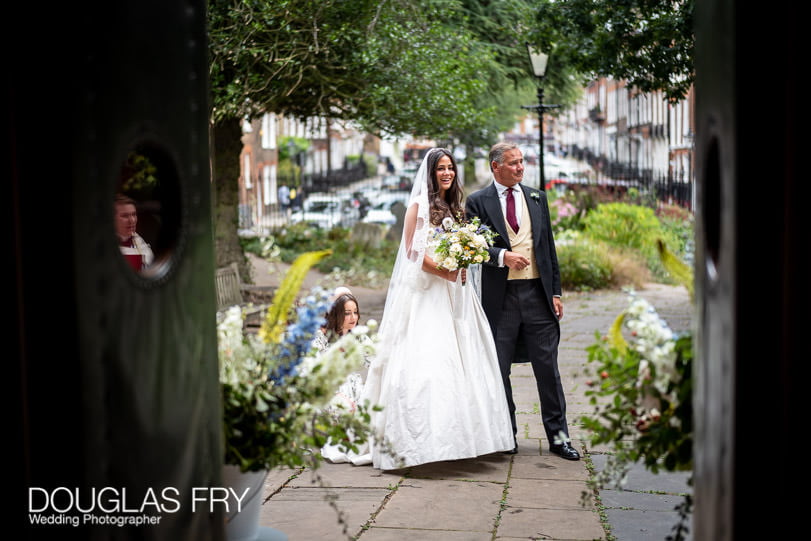 Bride arriving at church with father in london