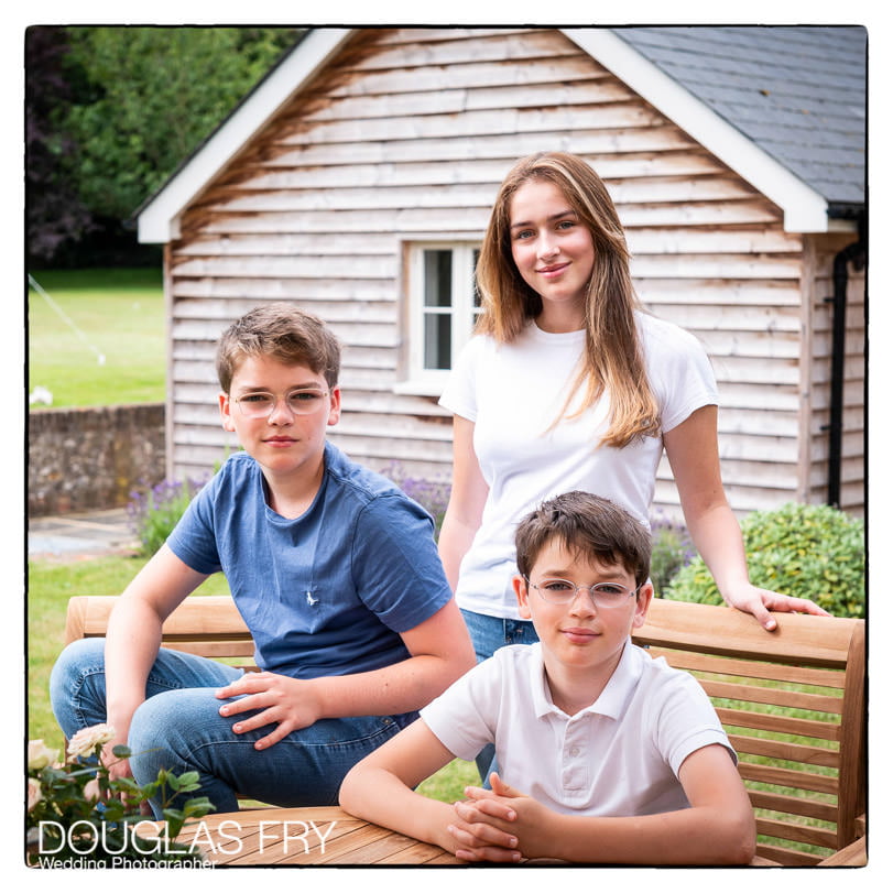 Teenage children and dog photographed at home in Wiltshire in the garden