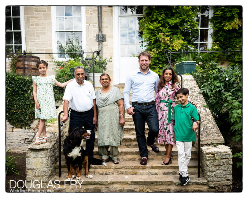 The whole family photographed together in front of the house