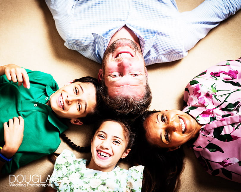 fun family photograph of heads together on the floor at home