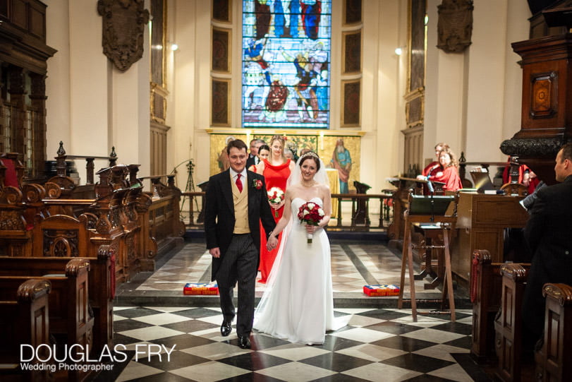 Bride and groom leaving church - wedding photograph