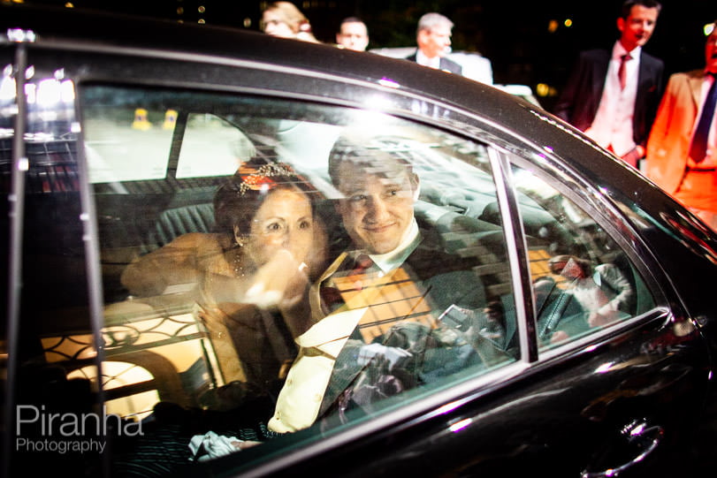 Bride and groom leaving HAC in car