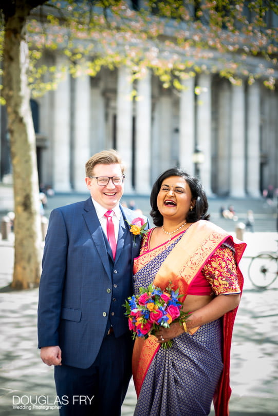 Bride and groom photographed together in London on tour in taxi